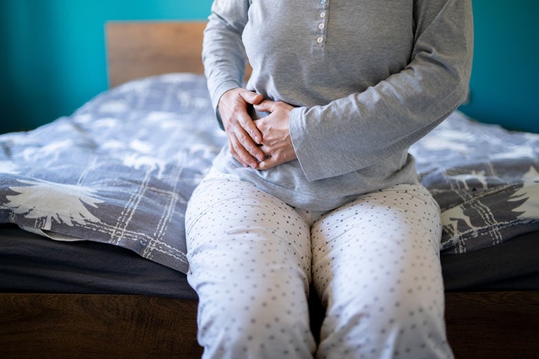 Female holding right side of stomach