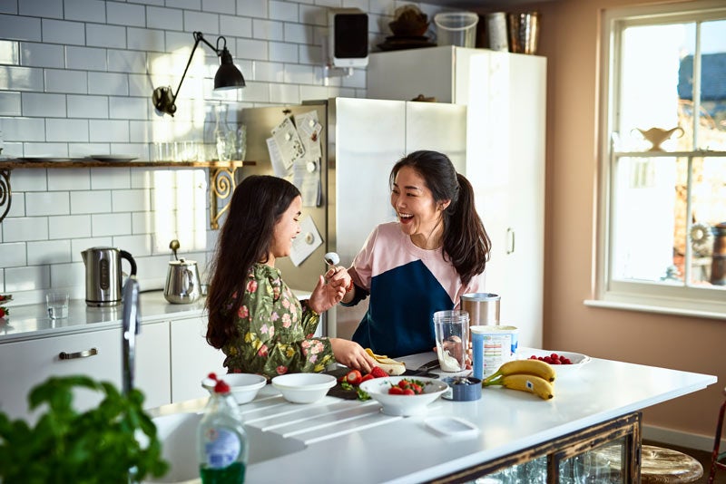 Mother cooking in the kitchen with her daughter