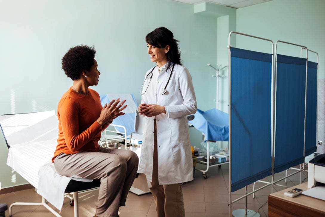 Surgeon consulting with patient in exam room