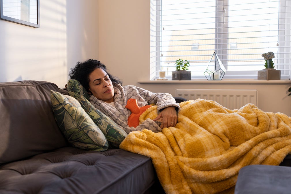 Laying on couch with hot water bottle