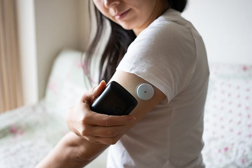 Woman checking her glucose levels